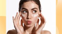 Close up beauty girl with freckles and thick eyebrows, applying moisturizing skincare cream, lotion or mask for skin lifting and anti-aging detoxifying effect, white background. 1941572701