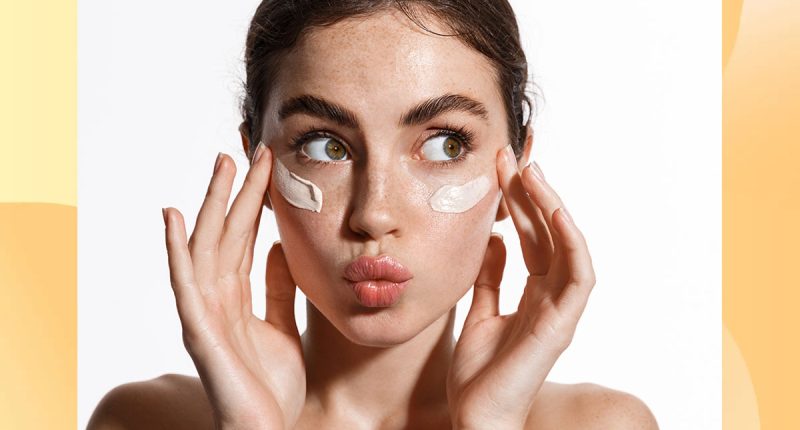 Close up beauty girl with freckles and thick eyebrows, applying moisturizing skincare cream, lotion or mask for skin lifting and anti-aging detoxifying effect, white background. 1941572701