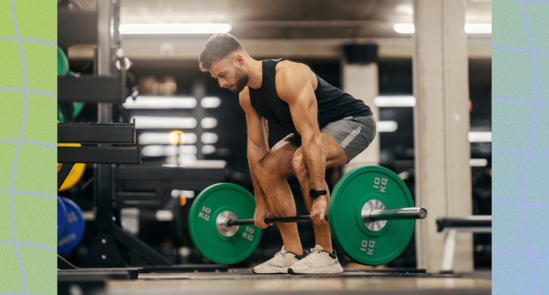 fit, muscular man doing a barbell deadlift in weight room of a gym