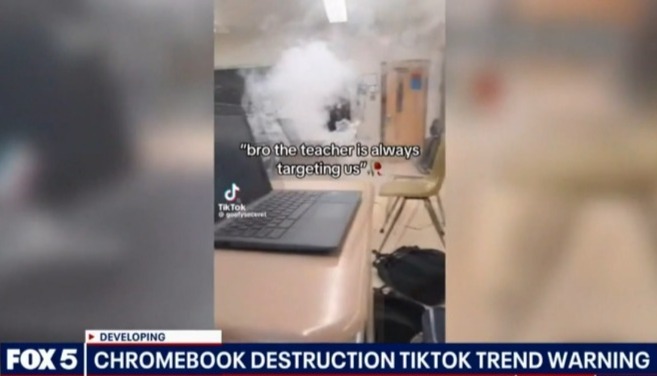Screenshot of a news report about a TikTok trend of Chromebook destruction in a classroom.