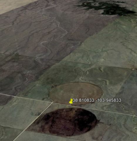 Aerial view of farmland with circular patterns.