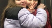 Two teenage girls hugging.