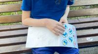 An eight-year-old boy looking at stickers.