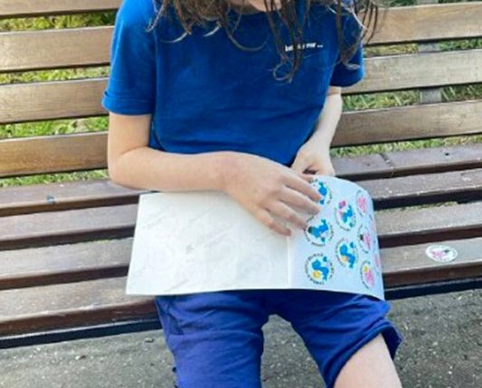 An eight-year-old boy looking at stickers.