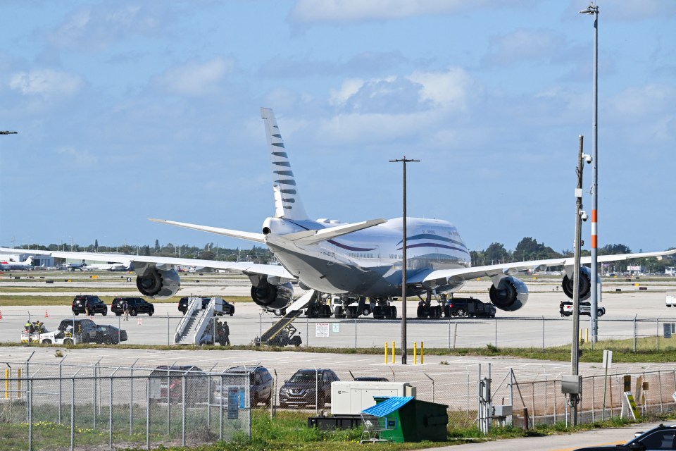Boeing 747 on tarmac at Palm Beach International Airport with motorcade.