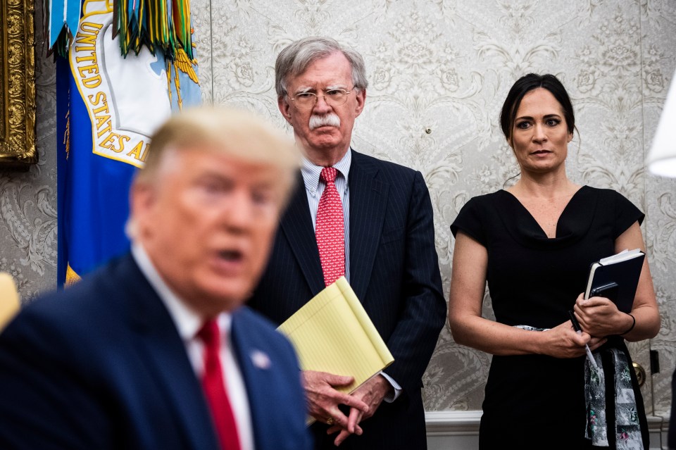 John Bolton and Stephanie Grisham listen as President Trump meets with the Amir of Qatar in the Oval Office.