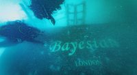 Underwater photo of divers exploring the sunken Bayesian yacht.
