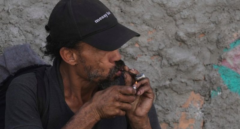 Person smoking crack cocaine.