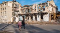 People walk through the heavily damaged town of Izyum, Ukraine.