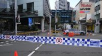 Police block a street near a crime scene at Bondi Junction in Sydney, Sunday, April 14, 2024, after several people were stabbed to death at a shopping center Saturday. Police have identified Joel Cauchi, 40, as the assailant that stabbed several people to death at a busy Sydney shopping center Saturday before he was fatally shot by a police officer. (AP Photo/Rick Rycroft)
