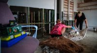 TAREE, AUSTRALIA - MAY 23: Business owners clean their shop following a flood at Albert street on May 23, 2025 in Taree, Australia. Catastrophic flooding struck the Mid North Coast and other parts of New South Wales, isolating over 50,000 residents, prompting hundreds of rescues, and leaving at least one person dead and several missing as emergency services responded to record-breaking rainfall. (Photo by Roni Bintang/Getty Images)