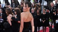 Georgia Fowler sports a plaster on her arm as she storms red carpet in a sparkling black gown for The History Of Sound premiere at Cannes Film Festival