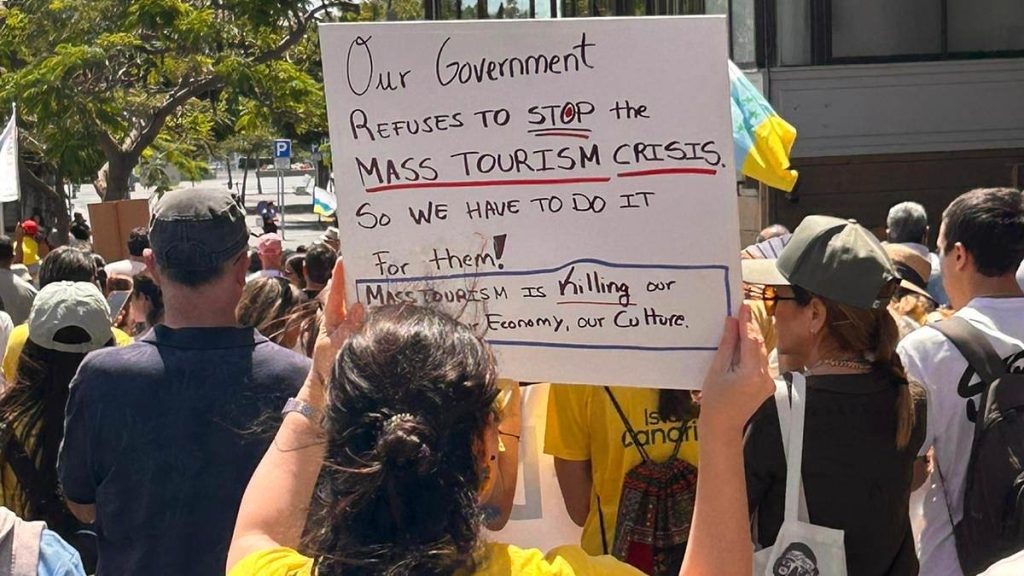 Holidaymakers too scared to leave their rooms as thousands of anti-tourism protesters take to the streets of the Canary Islands