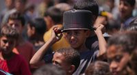 Hungry Palestinians in Gaza block and offload dozens of UN food trucks