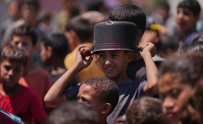 Hungry Palestinians in Gaza block and offload dozens of UN food trucks