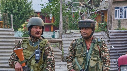 Indian soldiers stand guard at Pampore, in Indian-administered Kashmir, on May 7, 2025.
