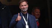 Jurgen Klopp poses with grinning Arne Slot as former Liverpool boss toasts his successor on first return to Anfield for club's Premier League title party