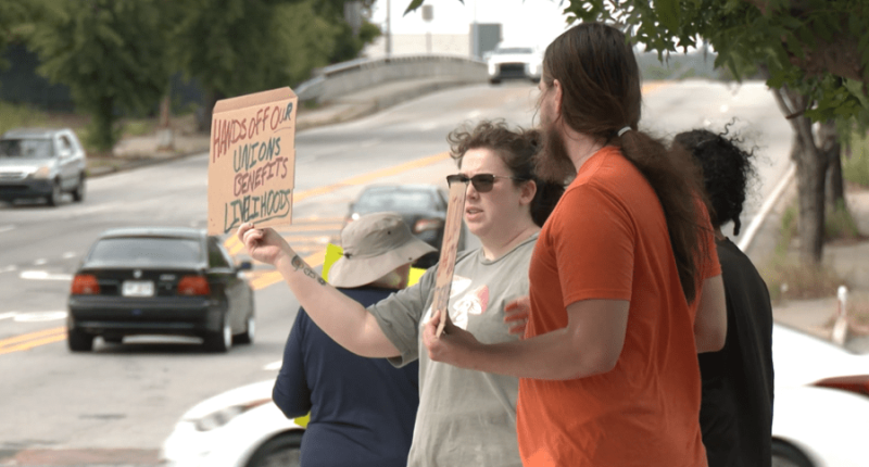 Local group protests union cuts on International Workers Day