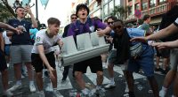 Man Utd and Tottenham yobs clash in the streets, strip naked and throw booze at each other before Europa League final... but meet their match when they take on the locals