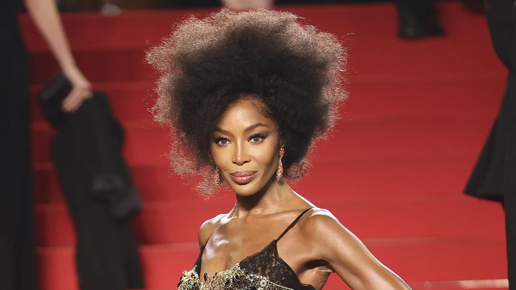 Naomi Campbell, 54, exudes glamour in a black and gold gown in Cannes