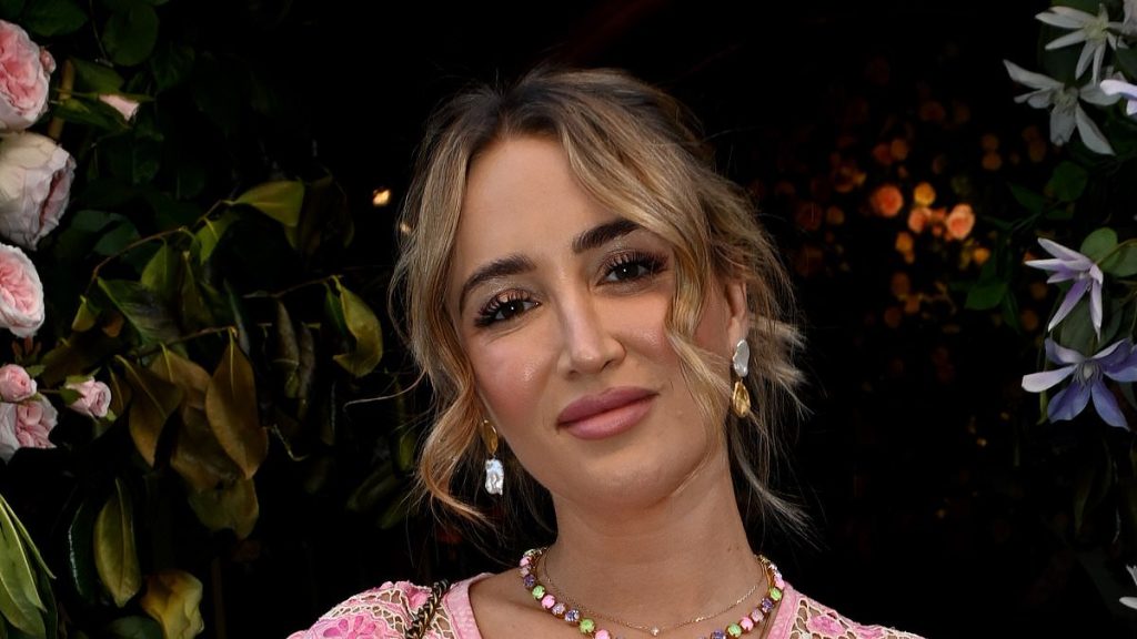 Pregnant Georgia Harrison proudly cradles her blossoming baby bump in a stylish pink dress as she heads to swanky London restaurant