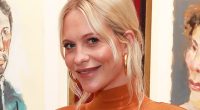 Pregnant Poppy Delevingne shows off her baby bump in a figure hugging orange dress as she attends Boy Dylan exhibition in London