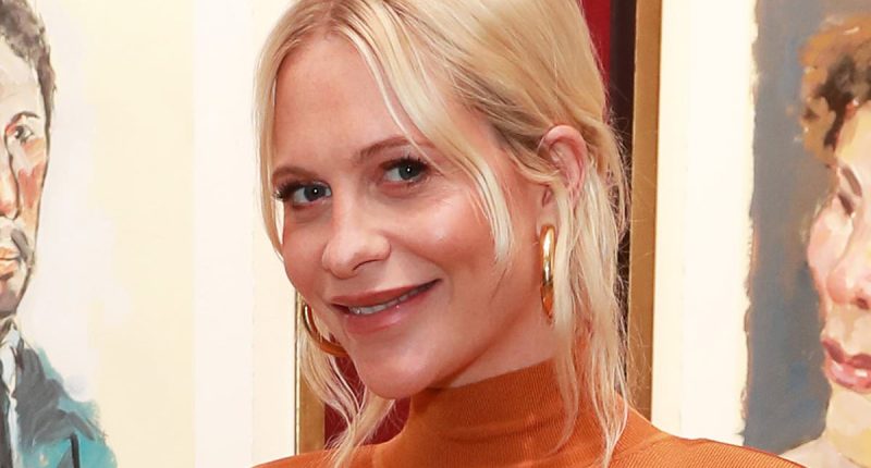 Pregnant Poppy Delevingne shows off her baby bump in a figure hugging orange dress as she attends Boy Dylan exhibition in London