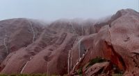 Stunning photos capture the rare moment water cascades down the sides of Uluru as mega rain bomb strikes Australia