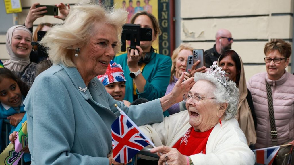 Sweet moment Queen Camilla is greeted by an excited supporter in Bradford as King Charles is wowed by famous magician's tricks