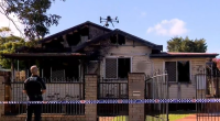 A nine-year-old boy is dead and a woman is under police guard after a suspicious house fire in Toowoomba, Queensland. ﻿