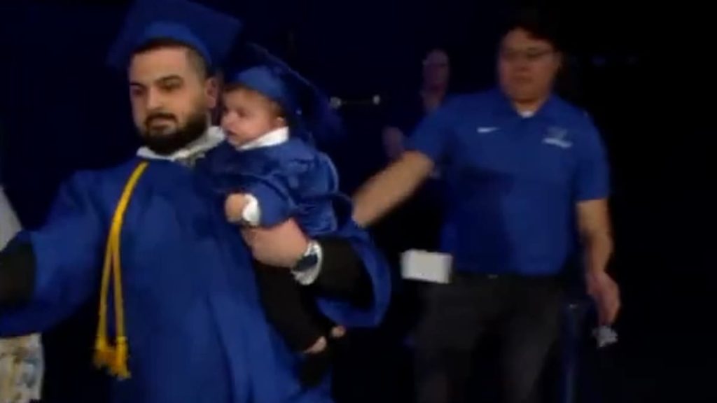 University at Buffalo graduate is chased off stage by police... but school has the last laugh
