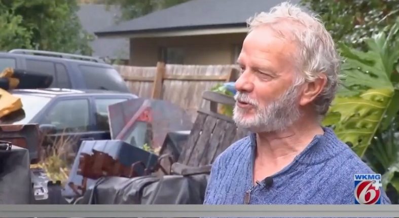 Alan Davis, Seminole County's "junk man," being interviewed amidst his cluttered yard.