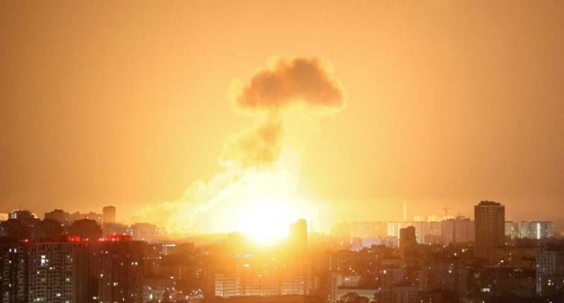 Ballistic missile explosion over a city at night.