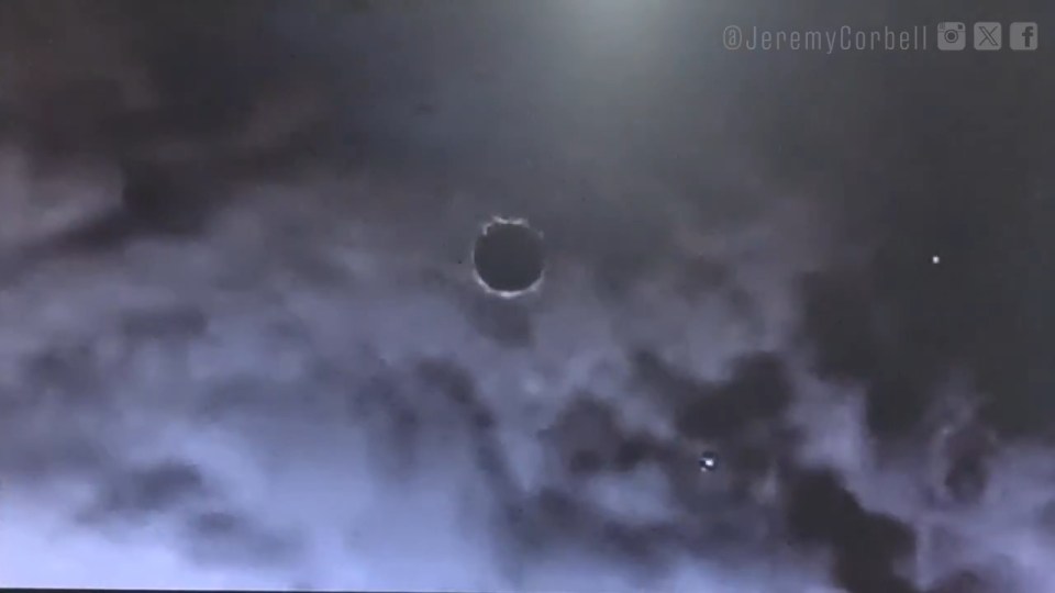 Disc-shaped object in cloudy sky.