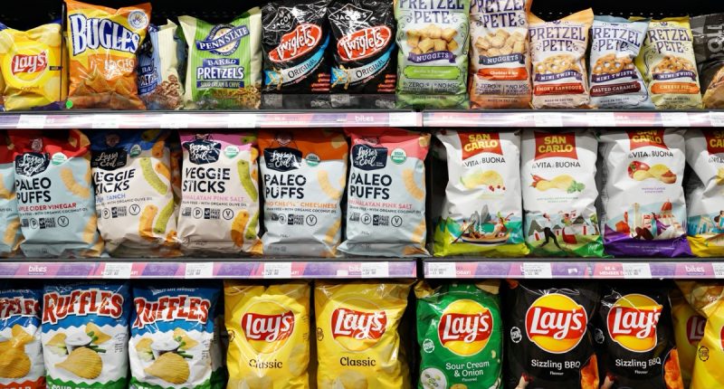 SELANGOR, MALAYSIA - 27 FEB 2022. Various imported brands of flavoured chips and snacks on store shelf in Village Grocer store. Village Grocer is the coolest fresh premium supermarket in Malaysia.