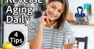Happy woman holding glass of pure water in modern kitchen. Healthy lifestyle hydration and daily wellness habit. Closeup portrait indoors