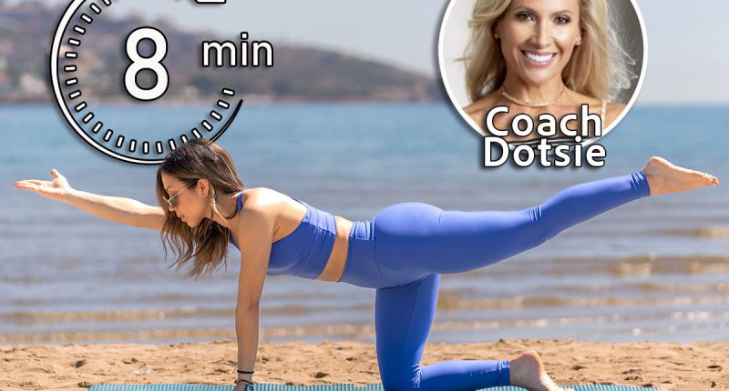 Dotsie Bausch, 5 Gentle Exercises That Loosen Your Body Better Than a Massage for Women Over 40, cover, A woman in blue performs the bird dog pose on a beach, extending one arm and the opposite leg. The serene ocean and distant hills enhance the tranquil setting of this fitness activity.