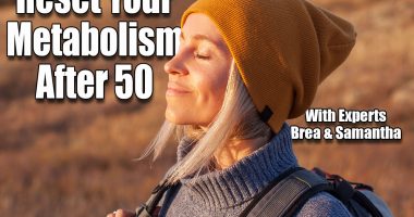 Middle age woman stretching arms breathing fresh air in a forest in autumn. Female traveler spends their vacations going hiking