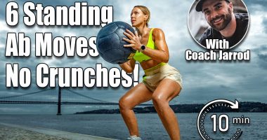 Woman in fitness wear doing workout with a heavy medicine ball outdoors.. Sporty girl with fit body in sportswear posing on sky background.