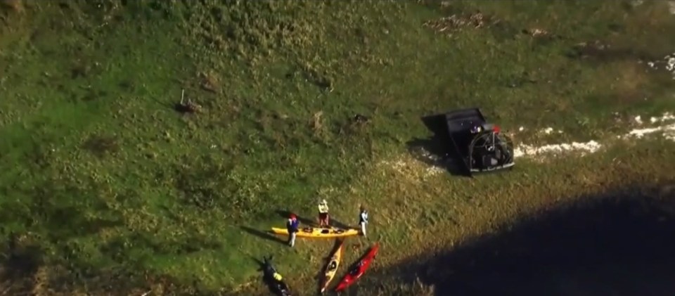 Aerial view of kayakers and a damaged kayak after an alligator attack.