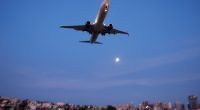Boeing 737 approaching San Diego International Airport at sunset.
