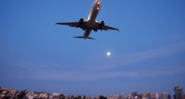 Boeing 737 approaching San Diego International Airport at sunset.