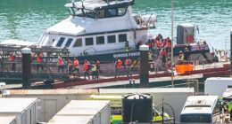 Migrants disembarking a Border Force vessel at Dover Docks.