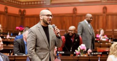 State Rep. Raghib Allie-Brennan speaking at a podium.