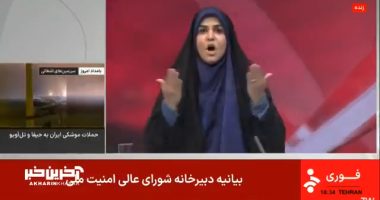 Screenshot of a news report showing a woman in a hijab reacting to news of missile attacks.