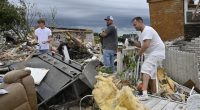 Volunteers help clean up debris from storm damage in the Sunshine Hills neighborhood in London, Ky., Monday, May 19, 2025
