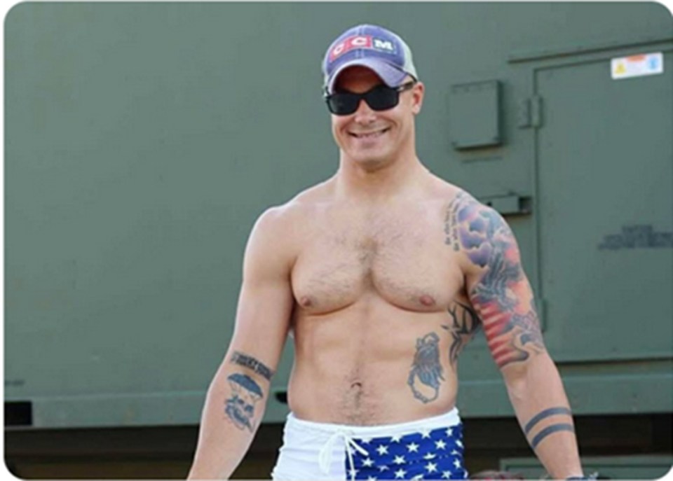 Photo of Travis Decker, showing his tattoos and physique.