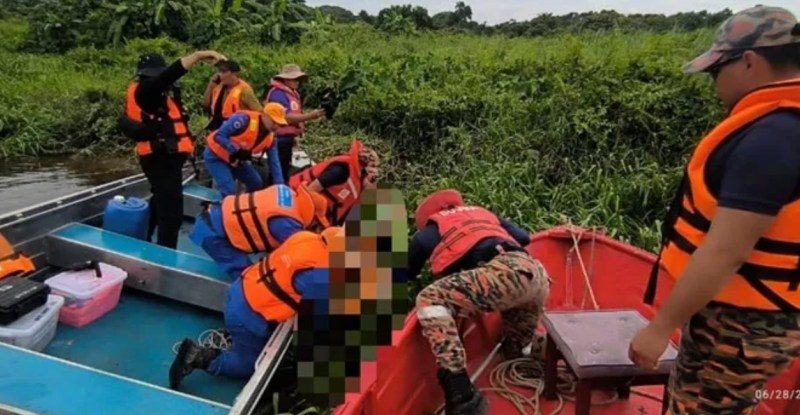 Rescue workers retrieving a body from a river.