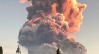 Volcanic eruption plume over a church.