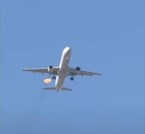 Flames erupting from an airplane in flight.